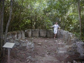 A tourist posing in front of some sugar mill ruins on St. John